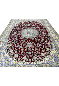 Wine red field with floral vine motifs and silk highlights on Persian Nain 9 LAA rug