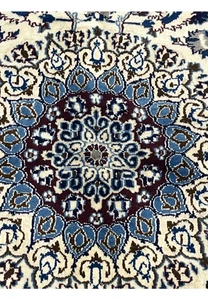 Close-up of the medallion on Square Persian Nain Rug with ivory, blue, and burgundy detailing