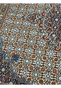 Close-up showcasing the Herati lattice pattern of rosettes and diamond motifs in ivory, blue, and brown, symbolizing tradition and Persian design balance.