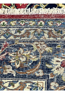 Backside of the 8'7 x 12'7 Distressed Persian Isfahan Rug revealing precise knotting, uniform weave structure, and wool texture showcasing authentic Persian quality.