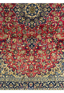 Lower part of the Isfahan Rug displaying navy and ivory floral borders and balanced medallion symmetry.