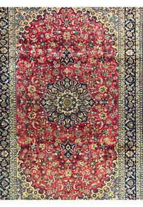 Midfield section of the Isfahan Rug showing the floral patterns and delicate vine motifs woven in wool with aged patina.