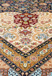 Angled perspective showing the sheen of silk threads and depth of color across the intricate floral design.