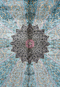 Detailed view of the intricate black and sky-blue medallion of the Chinese silk oriental rug