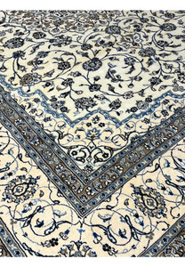 Close-up of 10' x 13'2 Persian Nain 9LA Rug corner with interlocking floral border and ivory-blue color contrast.