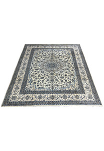 10' x 13'2 Persian Nain 9LA Rug laid flat to display ivory and blue floral pattern with central medallion and layered borders.