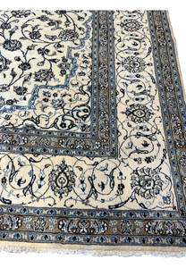 Folded edge of 10x13 Persian Nain 9LA Rug revealing border design, fine knot density, and shimmering silk highlights.