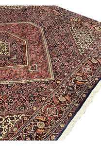 Mid-field detail of Bijar Persian rug showing continuous floral lattice pattern with fine medallion shapes and tonal layers of rust, beige, and navy.