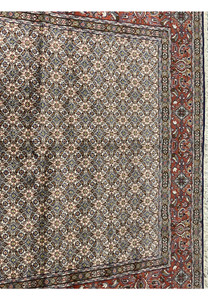 Close-up of all-over Moud Herati design with ivory, blue, brown, and red tones in fine wool texture.