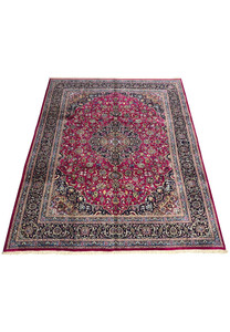 Top full view of Persian Mashad red wool rug showing floral medallion and navy borders.