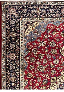 Border of 8'5 x 11'8 Persian Isfahan rug showing navy vines, ivory outlines, and detailed blossoms.