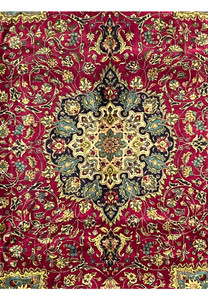 edge and fringe detail of Persian Tabriz rug with navy floral border and red outer band