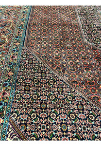 Close-up of Bijar rug field pattern with repeating rosettes, diamonds, and navy lattice outlines