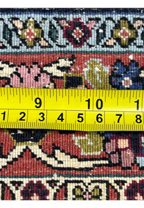 Backside knot density measurement of the Bijar rug with ruler showing tight handwoven wool knots.