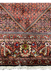 Lower border featuring floral palmettes and boteh motifs on the Bijar Persian Iron Rug.