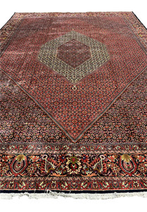 Flat overhead view of the Bijar Persian Iron Rug with octagonal medallion and red flower-filled field.