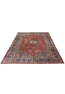 Top view of a 9'9 x 14'5 vintage Najafabad Persian rug with a ruby red field, navy border, and detailed floral medallion design.
