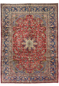Full view of the 9'9 x 14'5 vintage Najafabad Persian rug featuring a large medallion, ruby red field, and navy floral borders.