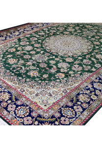 Angled view of 7x10 deep green Persian Nain 9LA rug showing navy border, ivory corner spandrels, and detailed floral vine pattern