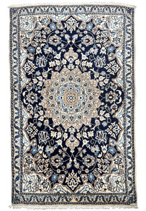 Full view of 3x5 Persian Nain rug with dark navy blue field, ivory border, sky blue floral details, and central ivory medallion
