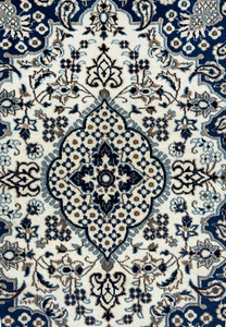 Close up of ivory and powder blue medallion on royal navy blue Persian Nain rug with mocha brown outlines and floral rosette pattern
