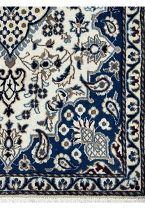 Border detail of Persian Nain rug with royal navy blue background, ivory floral motifs, powder blue accents, and scrolling vine patterns