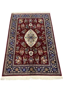 Top view of Persian Isfahan rug showing symmetrical medallion design and detailed floral field