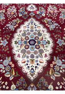 Close-up of ivory central medallion on Persian Isfahan rug with intricate silk floral detailing