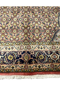 Lower border detail of Persian Bijar iron rug with navy ground and repeating floral motifs