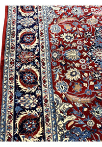 Border closeup of Persian Tabriz rug showing navy main border, light blue guard borders, and ivory floral elements