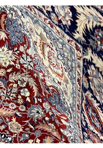 Color close-up of burgundy Persian Tabriz rug highlighting navy blue floral motifs, ivory accents, and light blue detailing
