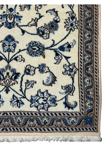 Detailed view of Persian Nain rug border with scrolling vines and blue accents