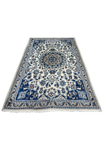 Top view of Persian Nain rug showing ivory field, blue medallion, and symmetrical floral layout