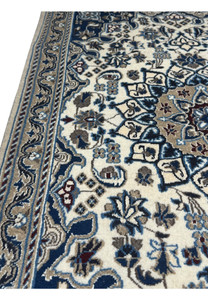 Cotton foundation and fine knot structure visible on back of Persian Nain rug