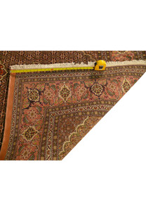 Backside of handwoven Persian Tabriz Mahi rug showing tight knot structure