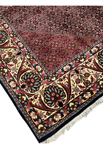 Edge detail showing the firm construction and tightly packed wool pile of a Persian Bijar iron rug