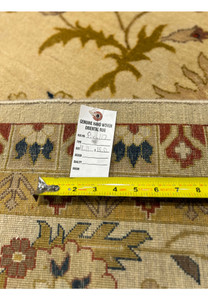 Backside view of a 12x15 Indian Jaipur oversize wool rug with ruler showing tight hand woven construction