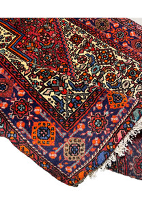 Backside of a Persian Gholtogh rug revealing tight knot structure, even weaving, and craftsmanship quality through visible foundation pattern