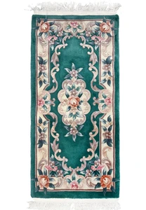 Full view of a 2'3 x 4'7 Aubusson Art Deco rug with emerald green field, ivory border, and raised floral scrollwork in soft pastel tones