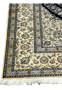 Border detail of Persian Nain 6 La rug with layered guard borders, floral scrollwork, and refined ivory and blue tones