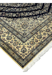 Edge detail of Persian Nain 6 La rug showing clean binding, fine knotting, and smooth silk foundation structure