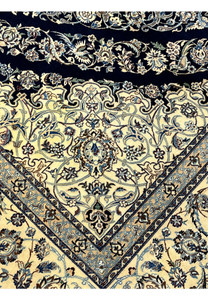 Inner edge detail of a Persian Nain 6 La rug showing ivory ground, fine floral scrollwork, and crisp silk outlines
