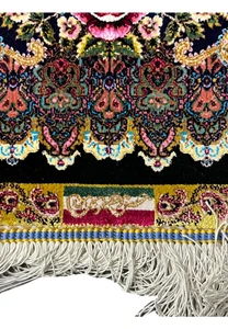 Woven signature detail on a signed Persian Qum pure silk rug confirming workshop authenticity