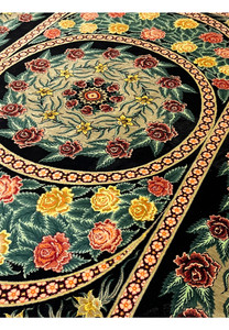 Angled view of a signed Persian Qum 100 percent silk rug highlighting natural silk sheen, fine knot density, and depth created by layered floral design