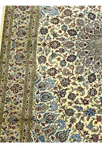 Side angle view of a 4'5 x 6'7 signed Persian Qum silk rug showing the sheen of pure silk fibers, tight knot structure, and refined border detailing.