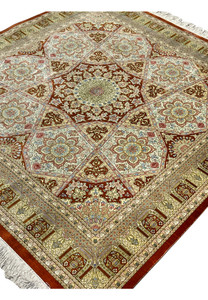 Top view of signed Amjadi Persian Qum silk square rug presenting symmetrical medallion design, ivory field, and luminous silk surface