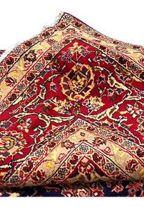 Folded edge view of Persian Isfahan rug showing thickness, durability, sharp pattern clarity, and tightly packed hand knotted wool