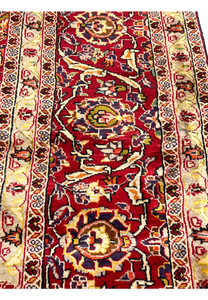 Border close-up of Persian Isfahan rug highlighting delicate floral rosettes, crisp outlines, ivory background, and precise hand knotted detail