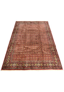 8'1 x 11'5 Persian Bijar rug laid flat showing dense red all-over geometric floral pattern and classic navy border