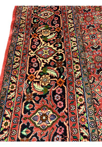 Border close-up of Persian Bijar rug displaying crisp floral detailing and saturated natural dyes